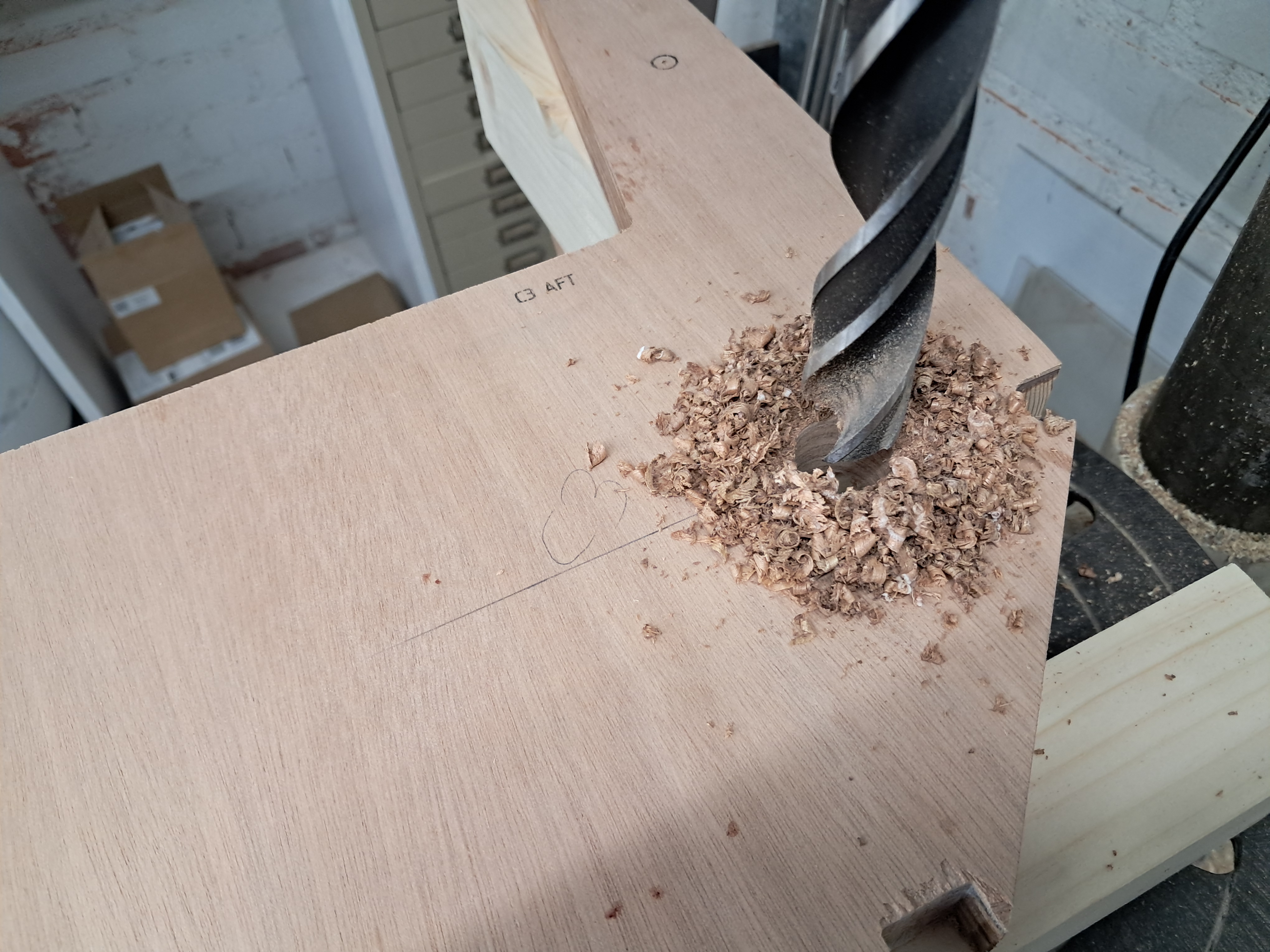 Close-up of the auger bit cutting the wing pin hole. I advanced slowly and kept checking alignment.