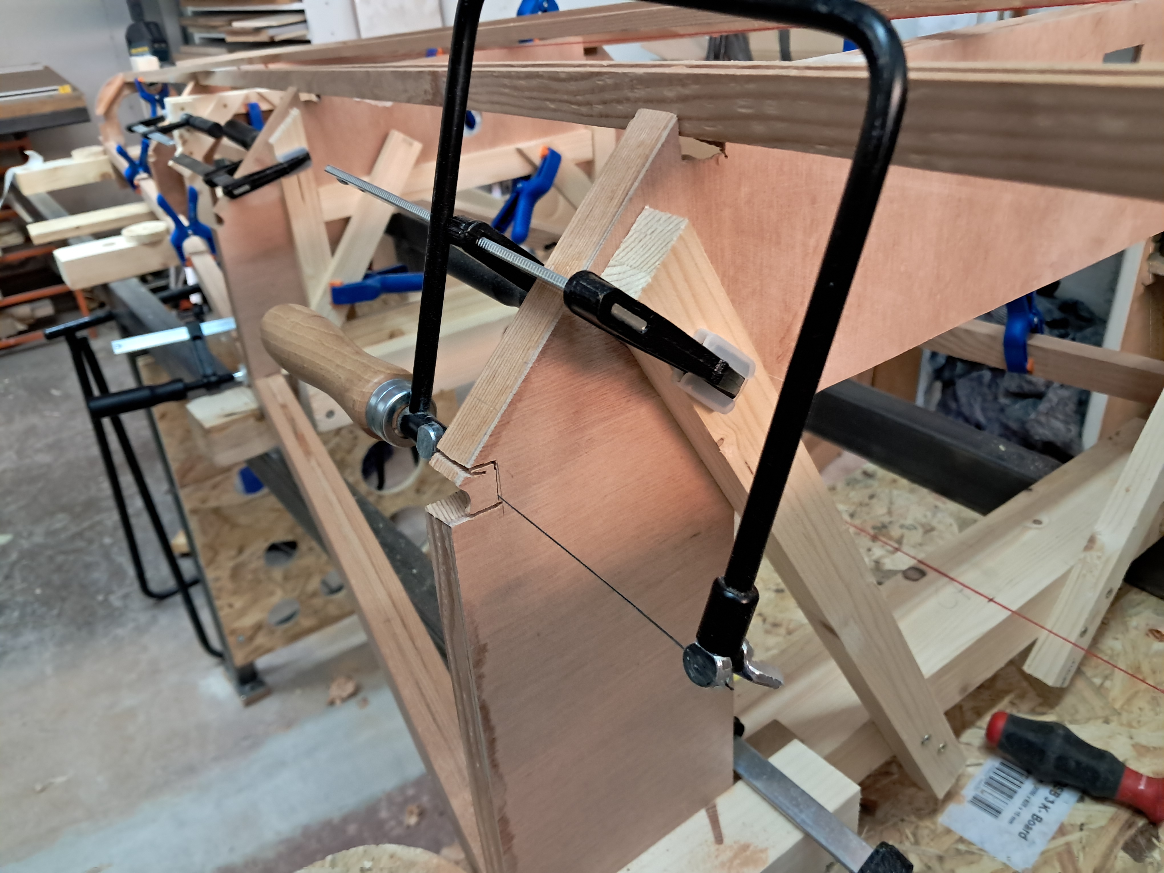 Rough-cutting the notches with a hand fretsaw.