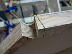 Close-up of a freshly opened longeron notch in a bulkhead. The notch is opened incrementally until the longeron seats at the correct lateral position and depth.