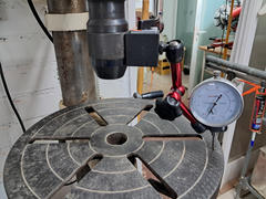 Levelling the drill press table to make sure the holes are drilled straight.