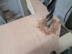 Close-up of the auger bit cutting the wing pin hole. I advanced slowly and kept checking alignment.